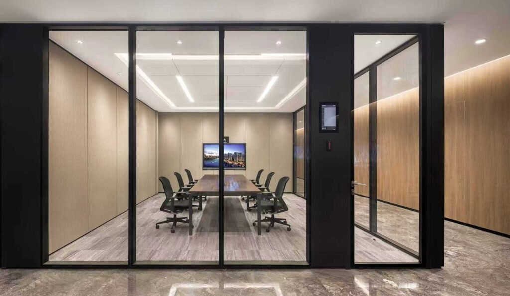 Soundproof meeting room enclosed by EGG-90A double glass partitions, featuring a minimalist black frame and excellent acoustic insulation for private discussions.