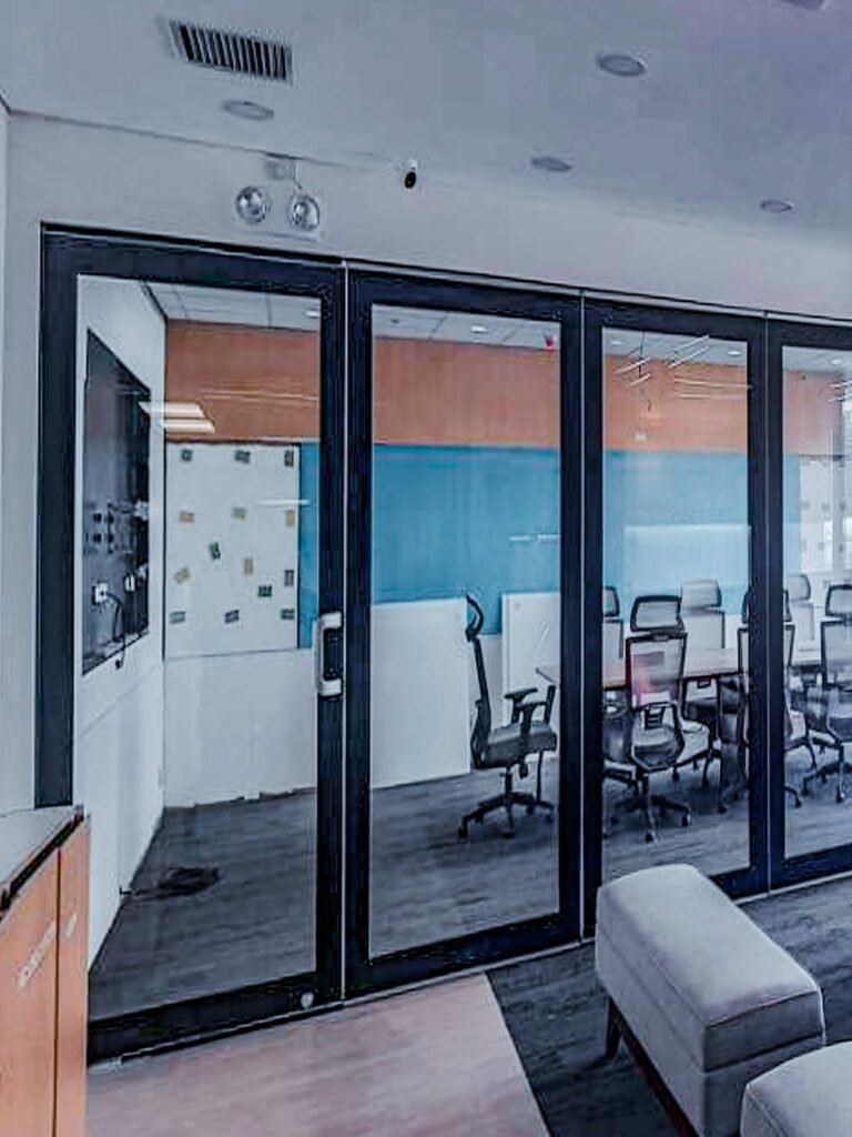 Classic Type 75 double-glazed glass partition with black frames, installed in a corporate office in the Philippines for a quiet, professional atmosphere.